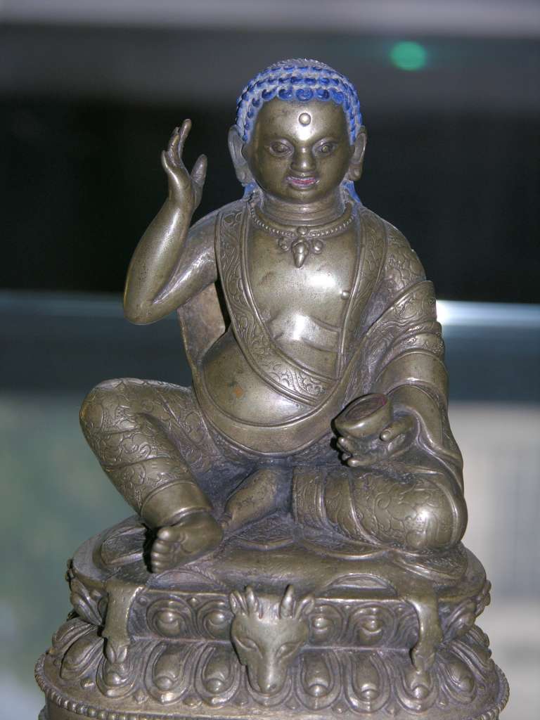 British Museum Top 20 Buddhism 18 Milarepa 18. Milarepa � Tibet, 18C AD or earlier, 12.8cm high. Milarepa ('the cotton clad', 1052-1135) is one of the most loved saints of Tibet. He is especially remembered for the huge number of songs he composed. He is considered a founder of the Kargyupa order of Tibetan Buddhism, though he himself was a disciple of Marpa. In this bronze image he is recognized by the right hand held up to his ear, indicating that he is reciting one of his celebrated poems or songs.